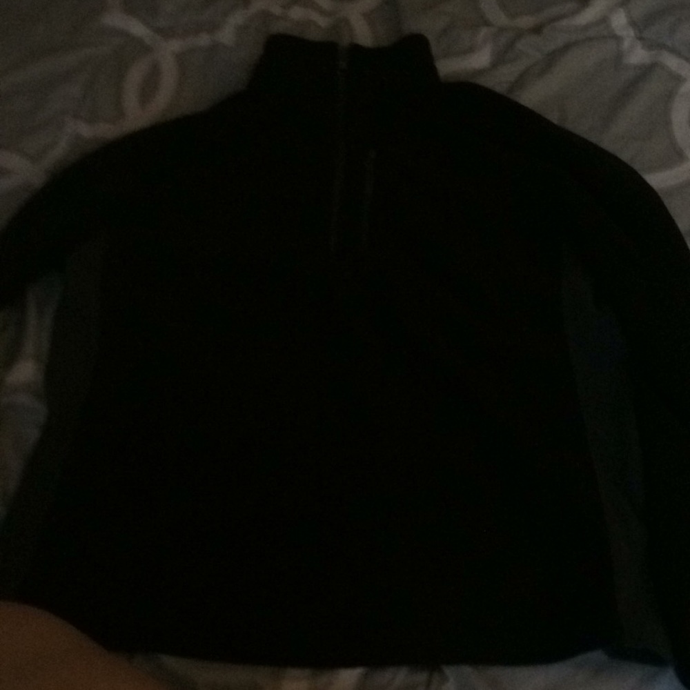 A black half zip up sweatshirt with a collar